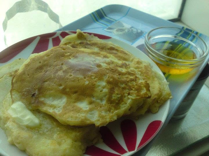 Homemade apple flapjacks served with maple syrup.