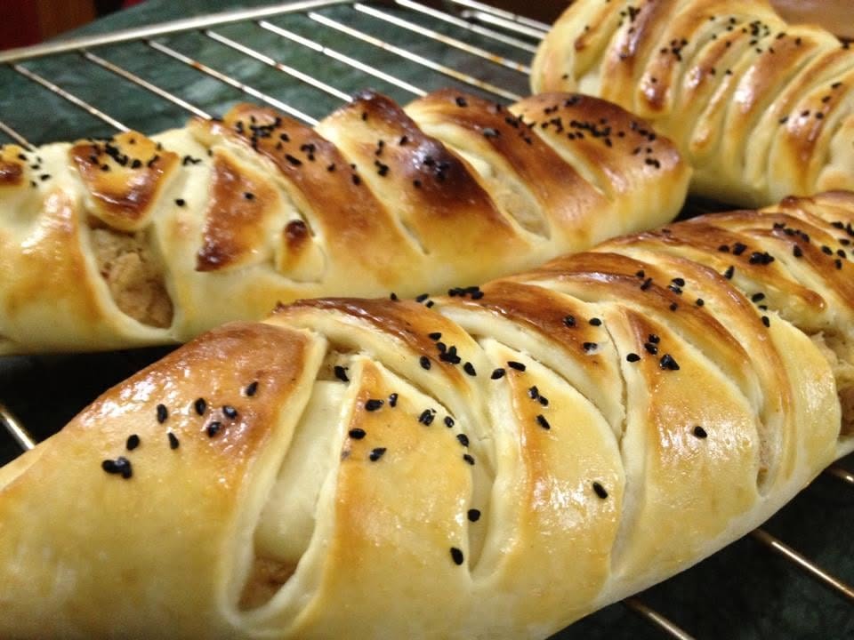 Homemade chicken bread with a golden braided top.