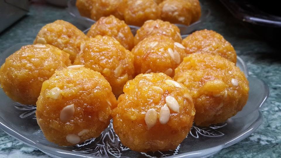 Homemade motichoor laddus garnished with nuts.