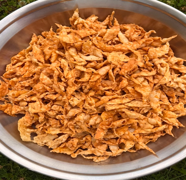 A large bowl filled with crisp, golden namak pare