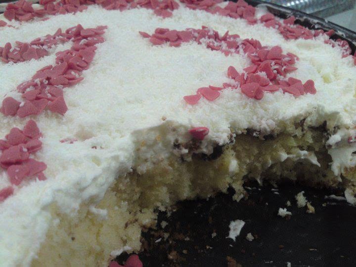Orange almond cake decorated with cream and berries.